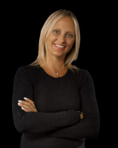 Adminstrative Assistant Karen Alers is Caucasian with blond hair. She is wearing a black shirt.